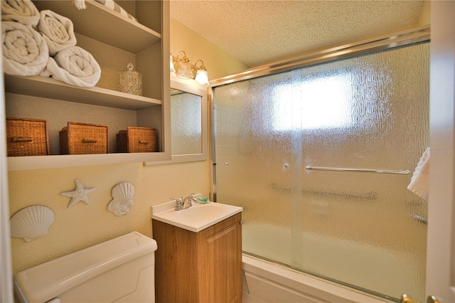 bathroom featuring vanity, a textured ceiling, and toilet