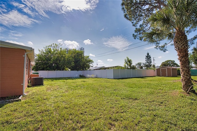 view of yard featuring a storage unit and central AC unit