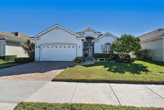 ranch-style home with a front yard and a garage