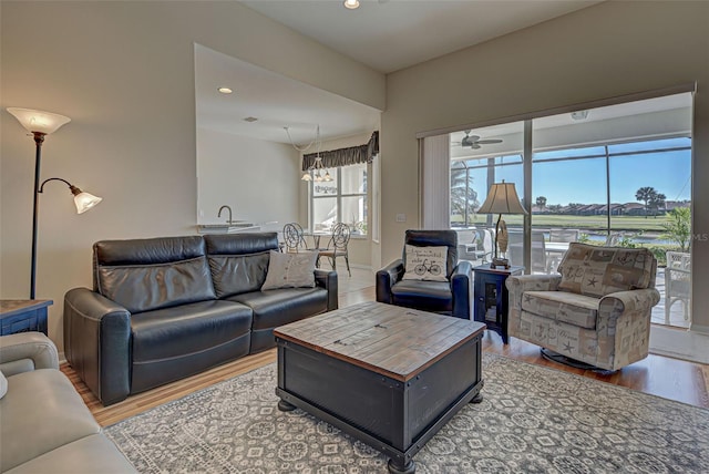 living room featuring hardwood / wood-style flooring and ceiling fan