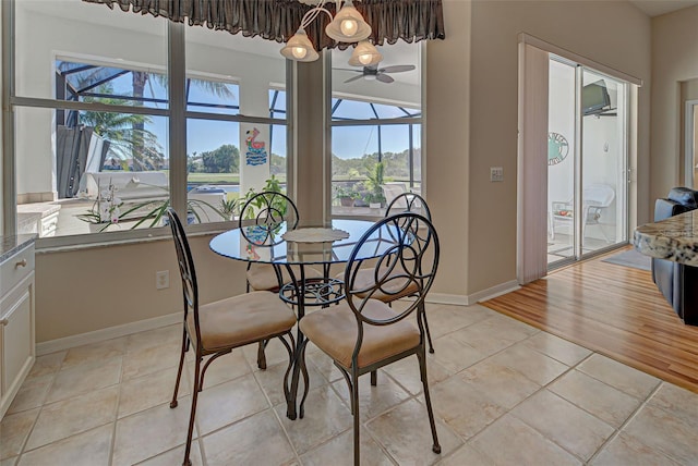 tiled dining area with ceiling fan and a wealth of natural light