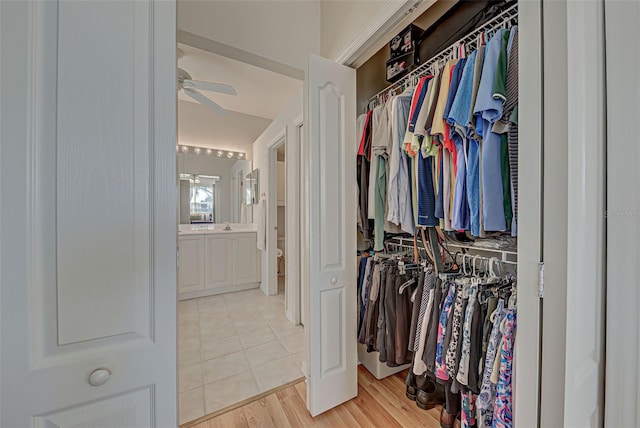 walk in closet with ceiling fan and light tile patterned floors