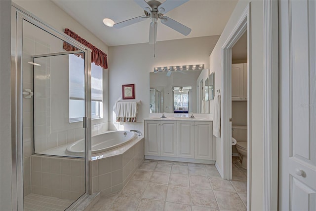 full bathroom with tile patterned floors, vanity, shower with separate bathtub, toilet, and ceiling fan