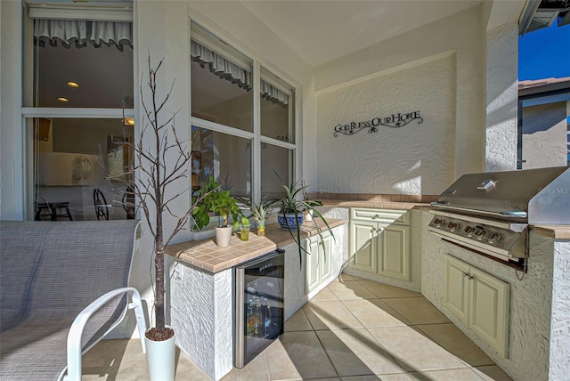 view of patio with a grill, beverage cooler, and area for grilling