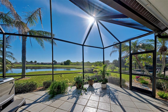 unfurnished sunroom featuring a water view