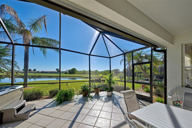 unfurnished sunroom featuring a water view