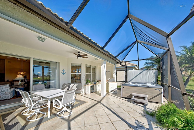 view of patio featuring ceiling fan, a lanai, and a hot tub