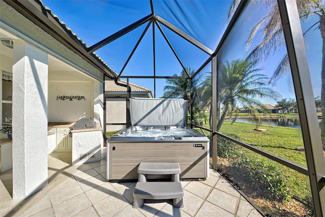 sunroom / solarium featuring a water view