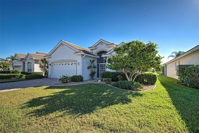 view of front of property with a garage and a front yard