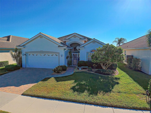 view of front of property featuring a garage and a front yard