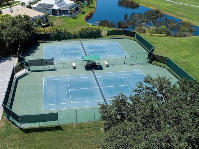 view of sport court featuring a lawn and a water view