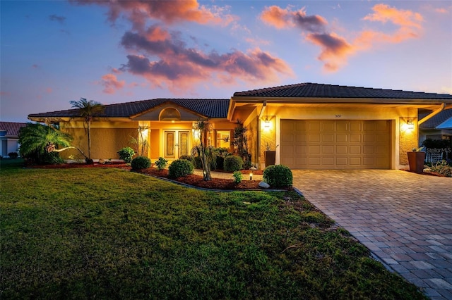 view of front of house with a lawn and a garage