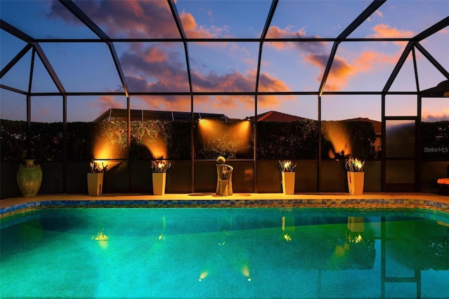 pool at dusk with a lanai