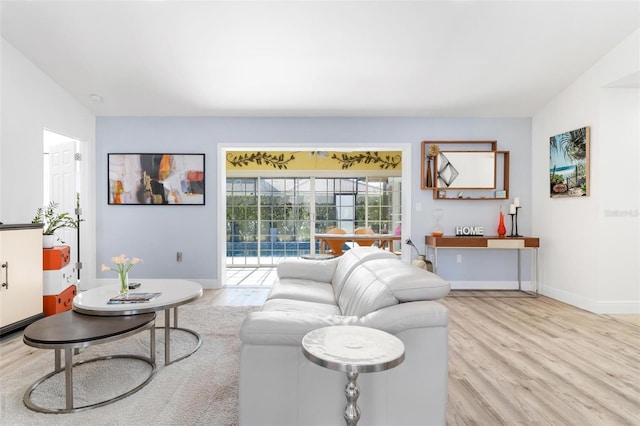 living room with light wood-type flooring and vaulted ceiling