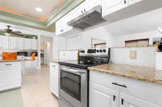 kitchen with electric range, white cabinets, and backsplash