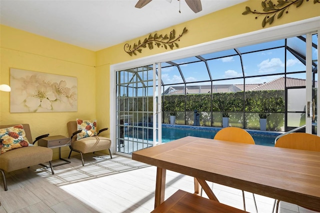 sunroom / solarium with a swimming pool, plenty of natural light, and ceiling fan