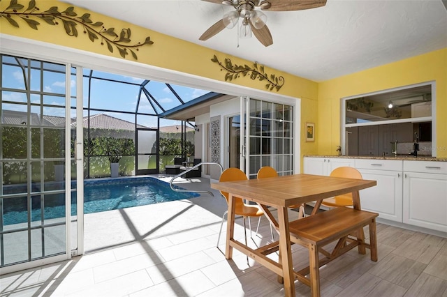 view of swimming pool with ceiling fan and sink