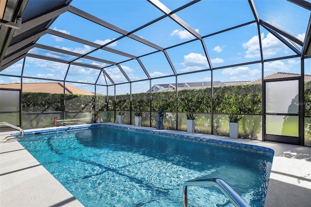 view of pool featuring glass enclosure