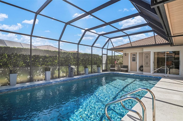 view of pool with a patio area and a lanai