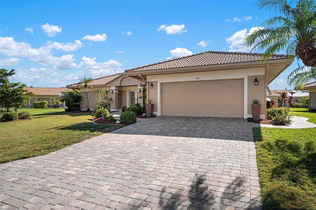 mediterranean / spanish house with a garage and a front yard