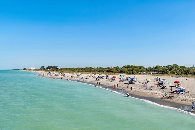 birds eye view of property featuring a water view and a beach view