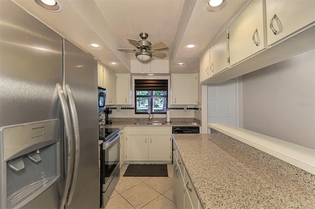 kitchen with light stone countertops, appliances with stainless steel finishes, ceiling fan, sink, and light tile patterned flooring