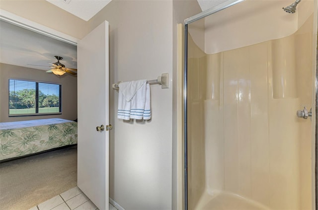 bathroom featuring tile patterned flooring, ceiling fan, and a shower