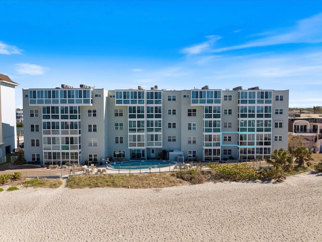 view of building exterior with a community pool