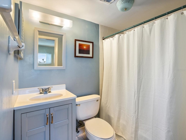 bathroom with vanity, toilet, and walk in shower