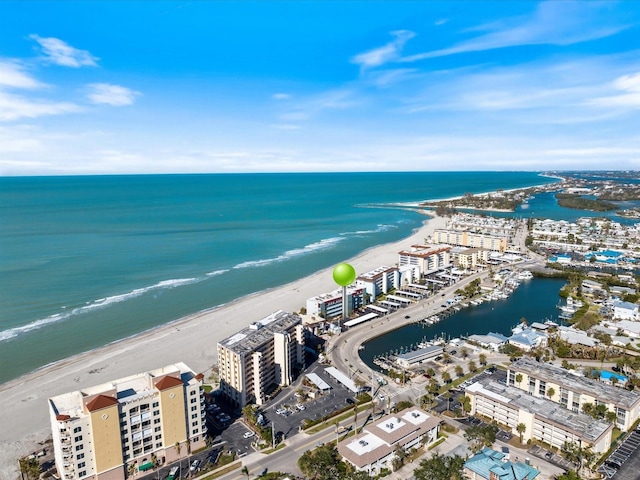 birds eye view of property featuring a water view and a beach view