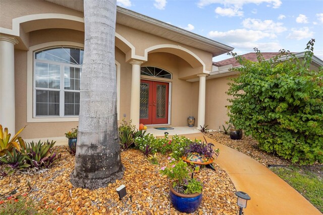 150 Marker Rd, Rotonda West, FL 33947 - property entrance featuring french doors and stucco siding