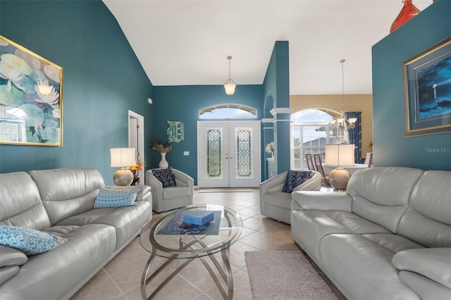 living room with french doors, light tile patterned floors, an inviting chandelier, and high vaulted ceiling