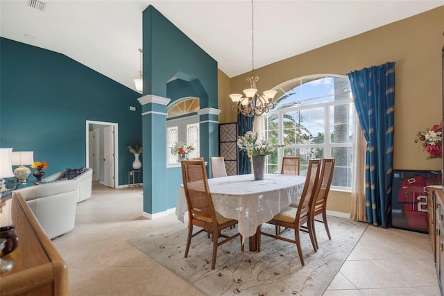 dining area with light tile patterned flooring, lofted ceiling, and a notable chandelier