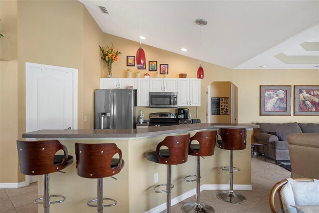 150 Marker Rd, Rotonda West, FL 33947 - kitchen with stainless steel appliances, light tile patterned floors, a breakfast bar area, open floor plan, and high vaulted ceiling