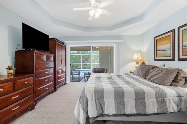 150 Marker Rd, Rotonda West, FL 33947 - bedroom featuring access to exterior, a raised ceiling, light colored carpet, and a ceiling fan