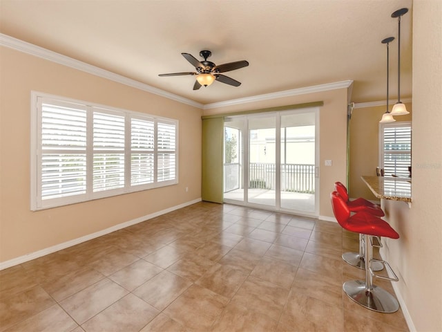 tiled empty room featuring ceiling fan and crown molding