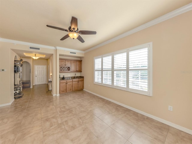 unfurnished living room with crown molding, ceiling fan, and light tile patterned flooring