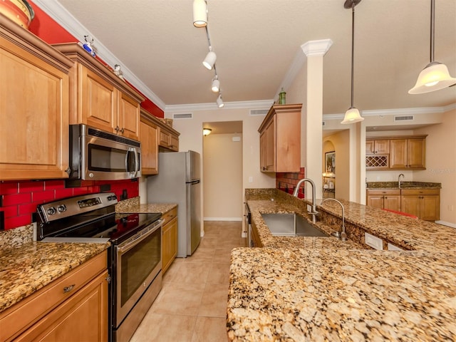 kitchen featuring sink, crown molding, pendant lighting, decorative backsplash, and appliances with stainless steel finishes