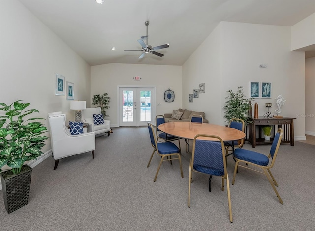 dining space with ceiling fan, vaulted ceiling, and french doors