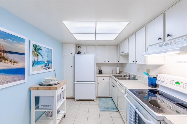 kitchen with white cabinets, white appliances, sink, and light tile patterned floors