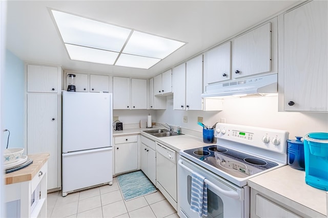 kitchen featuring white cabinets, light tile patterned floors, white appliances, and sink