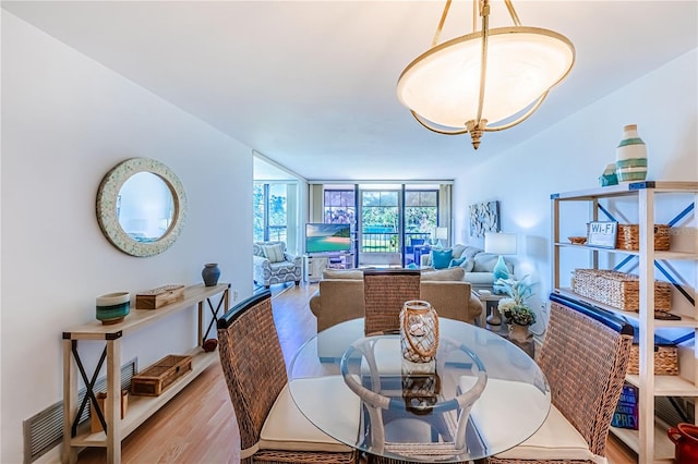 dining space featuring light hardwood / wood-style floors and floor to ceiling windows