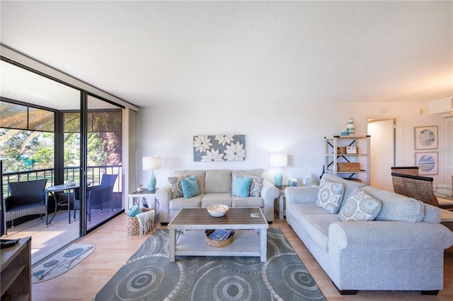 living room with expansive windows and light wood-type flooring