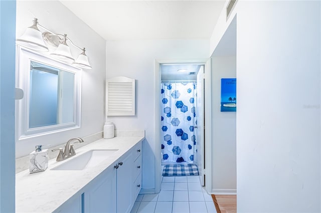 bathroom with tile patterned floors, vanity, and a shower with shower curtain