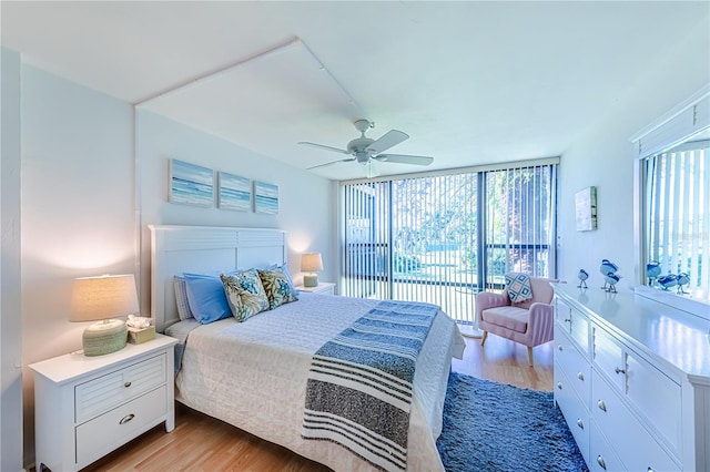 bedroom with multiple windows, ceiling fan, light hardwood / wood-style floors, and access to exterior