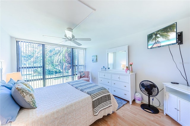 bedroom featuring access to outside, light hardwood / wood-style flooring, and ceiling fan