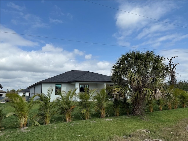 view of side of property with a lawn