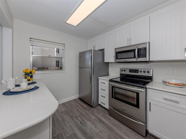 kitchen with white cabinetry, stainless steel appliances, and light hardwood / wood-style floors