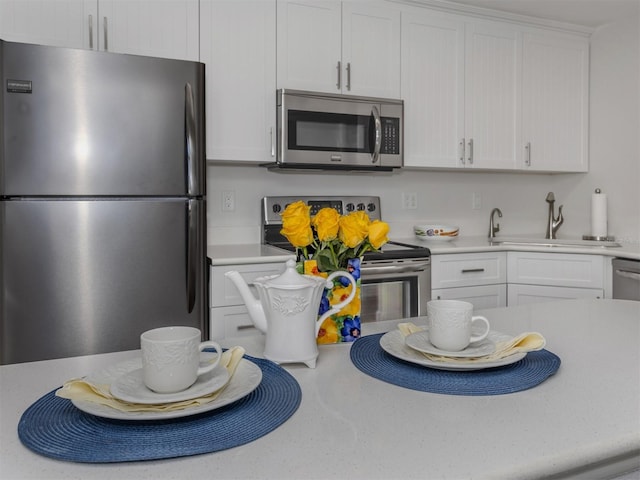 kitchen featuring sink, white cabinetry, and stainless steel appliances