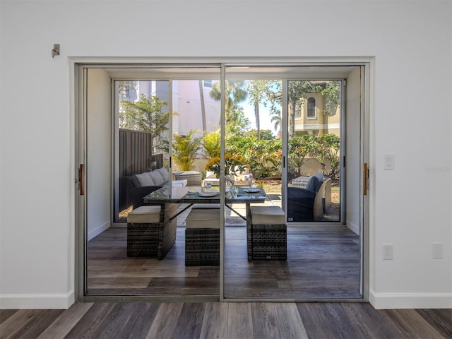 doorway to outside with a healthy amount of sunlight and dark hardwood / wood-style floors